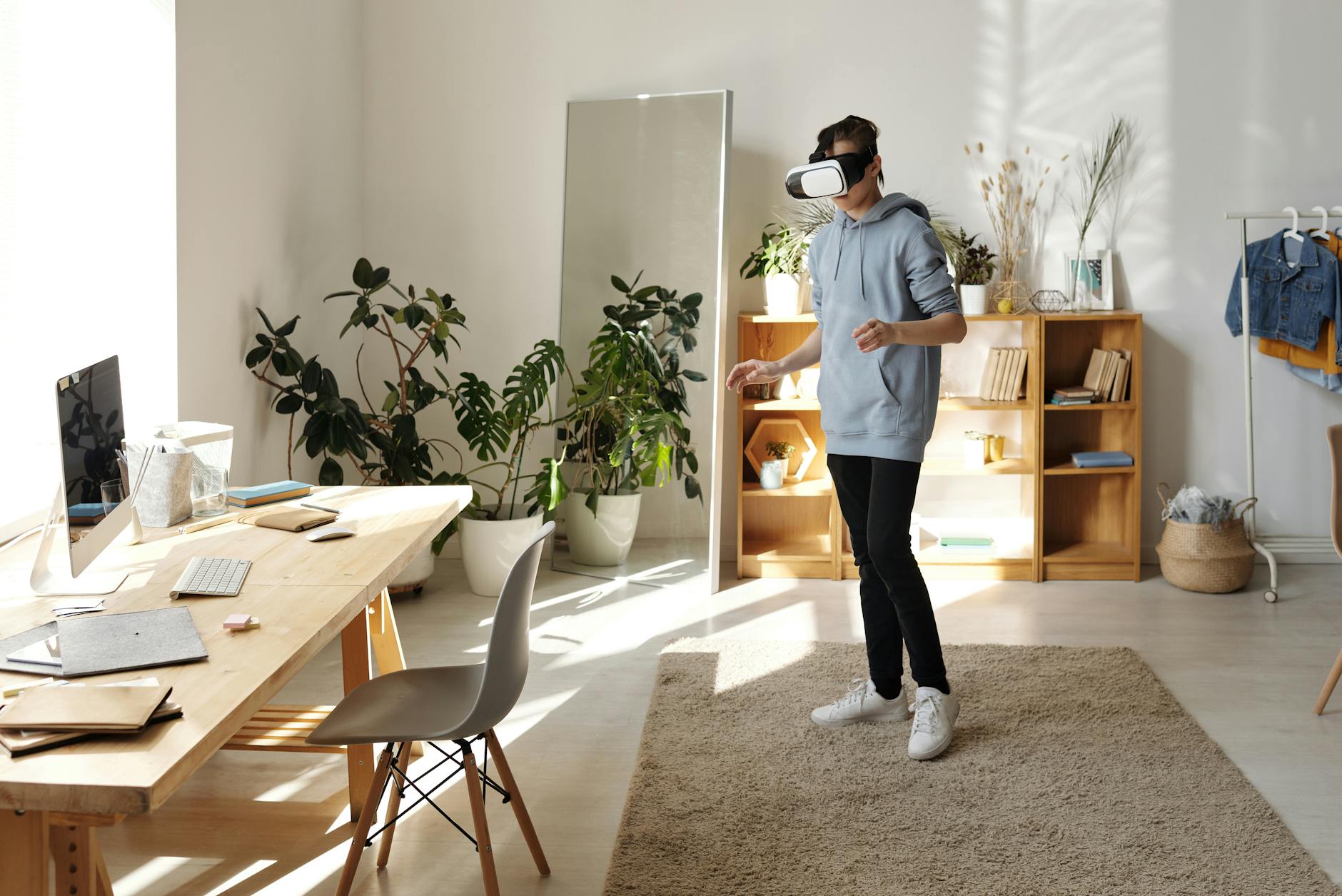 photo of boy standing while using vr headset